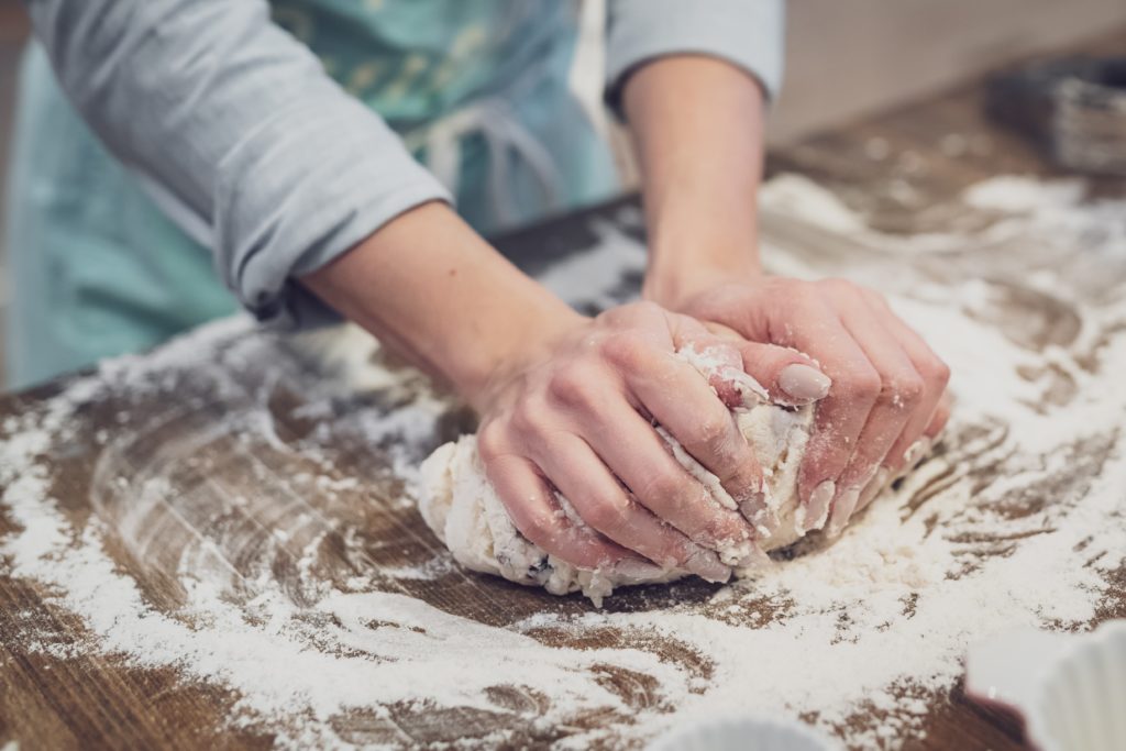 Woman's hands kneading dough